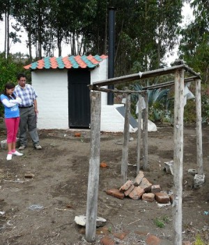 In front: the old pit latrine. In the back, the new Dry Toilet